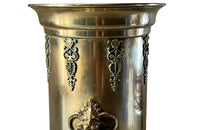 19th century brass umbrella or stick stand with lion head and bar handles and neo-classical style ornamentation.