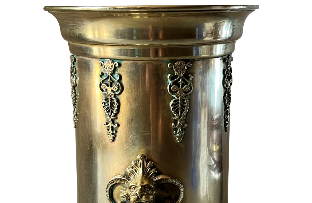 19th century brass umbrella or stick stand with lion head and bar handles and neo-classical style ornamentation.