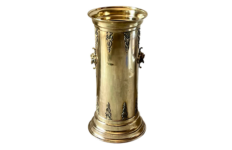 19th century brass umbrella or stick stand with lion head and bar handles and neo-classical style ornamentation.