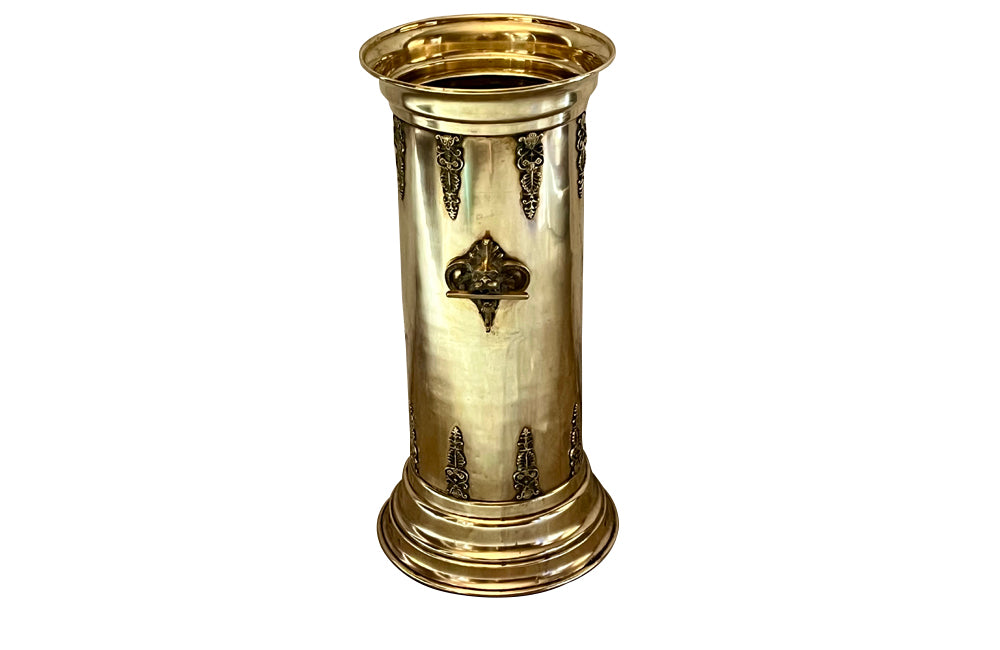 19th century brass umbrella or stick stand with lion head and bar handles and neo-classical style ornamentation.