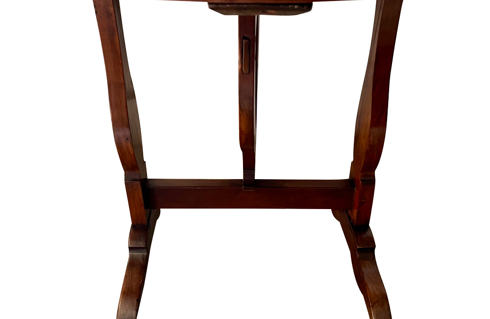 19th century small round cherry wood French vineyard table with turning lyre shaped support to shaped base