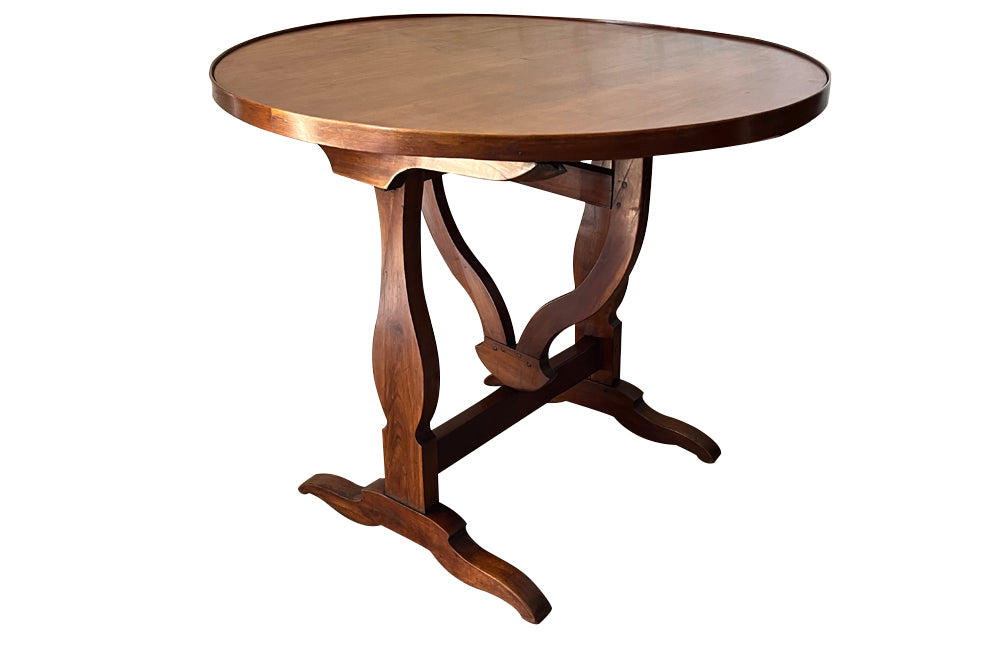 19th century small round cherry wood French vineyard table with turning lyre shaped support to shaped base
