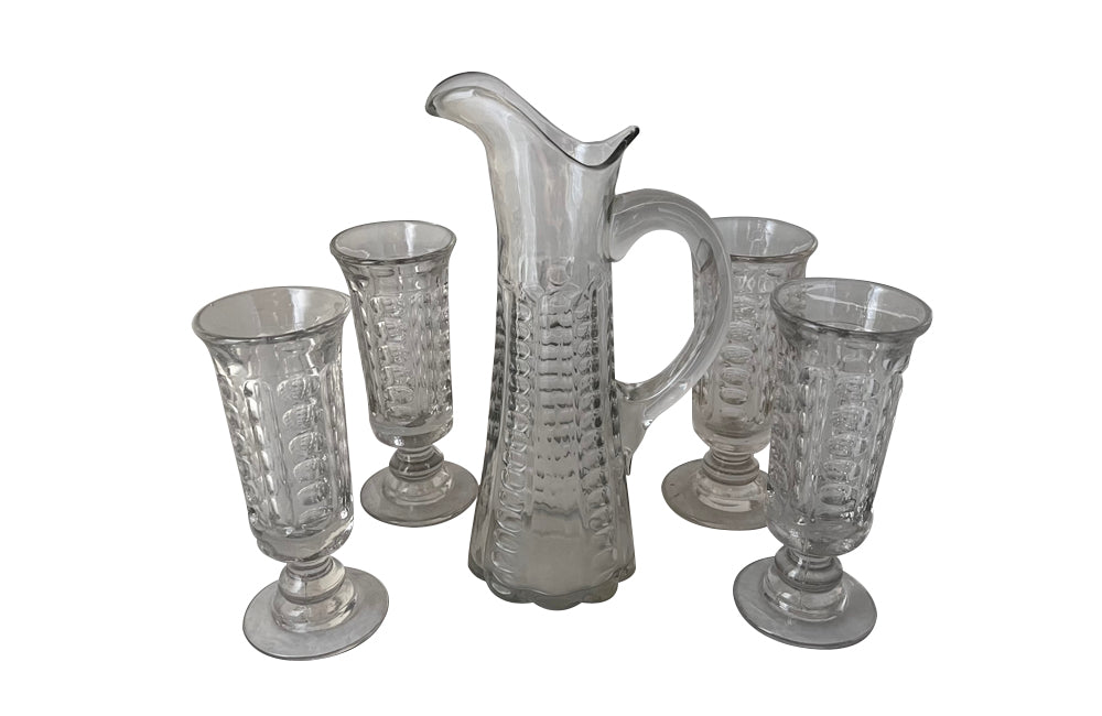 French 19th century Normandy glass jug and four matching tall stemmed glasses. 