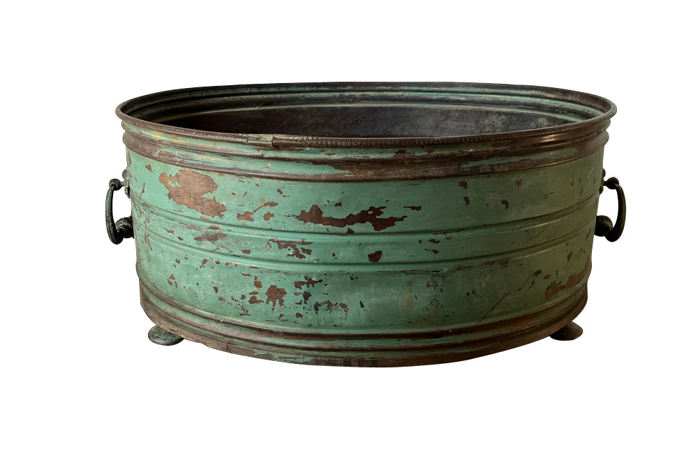 Large 19th century French copper jardiniere with worn verdigris coloured finish on three feet and two ornate swinging handles