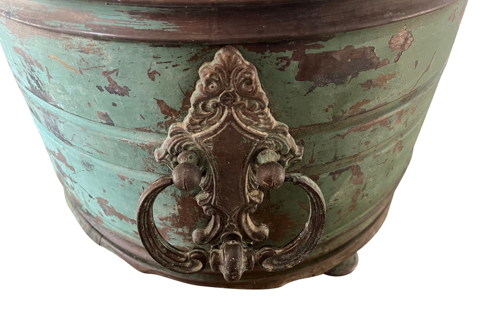 Large 19th century French copper jardiniere with worn verdigris coloured finish on three feet and two ornate swinging handles