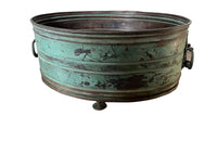 Large 19th century French copper jardiniere with worn verdigris coloured finish on three feet and two ornate swinging handles