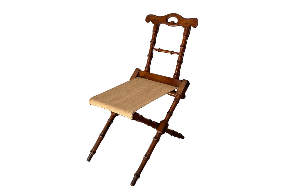 Charming little 19th Century French travel chair in faux bamboo with antique linen seat.