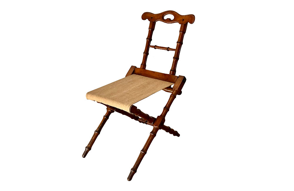 Charming little 19th Century French travel chair in faux bamboo with antique linen seat.