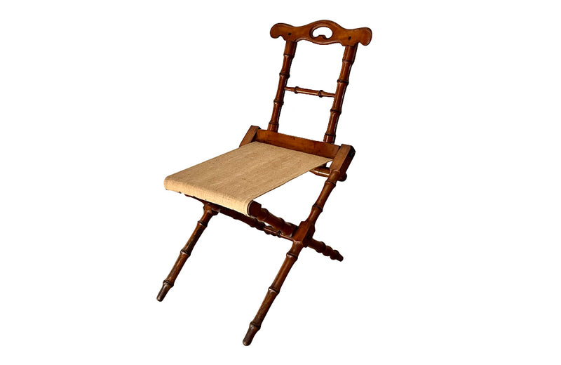 Charming little 19th Century French travel chair in faux bamboo with antique linen seat.