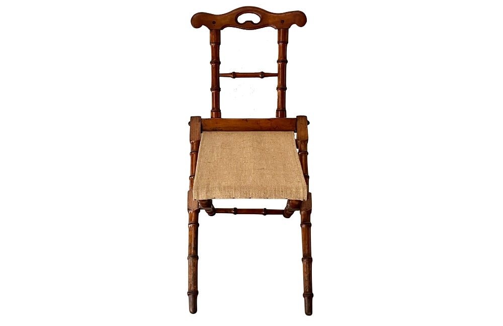 Charming little 19th Century French travel chair in faux bamboo with antique linen seat.
