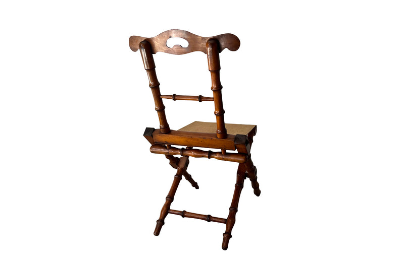 Charming little 19th Century French travel chair in faux bamboo with antique linen seat.