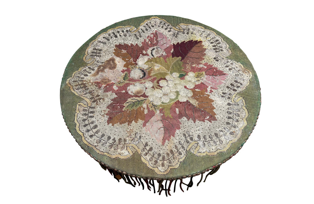 Charming 19th century faux bamboo occasional table with worn tapestry fabric top and decorative fringed surround.