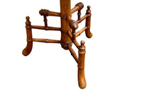 Charming 19th century faux bamboo occasional table with worn tapestry fabric top and decorative fringed surround.