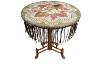 Charming 19th century faux bamboo occasional table with worn tapestry fabric top and decorative fringed surround.
