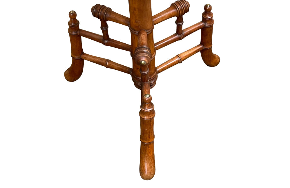 Charming 19th century faux bamboo occasional table with worn tapestry fabric top and decorative fringed surround.