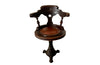 19th Century French carved wooden ships chair with leather seat and heavy cast iron base.