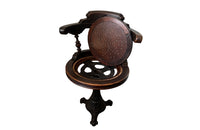 19th Century French carved wooden ships chair with leather seat and heavy cast iron base.