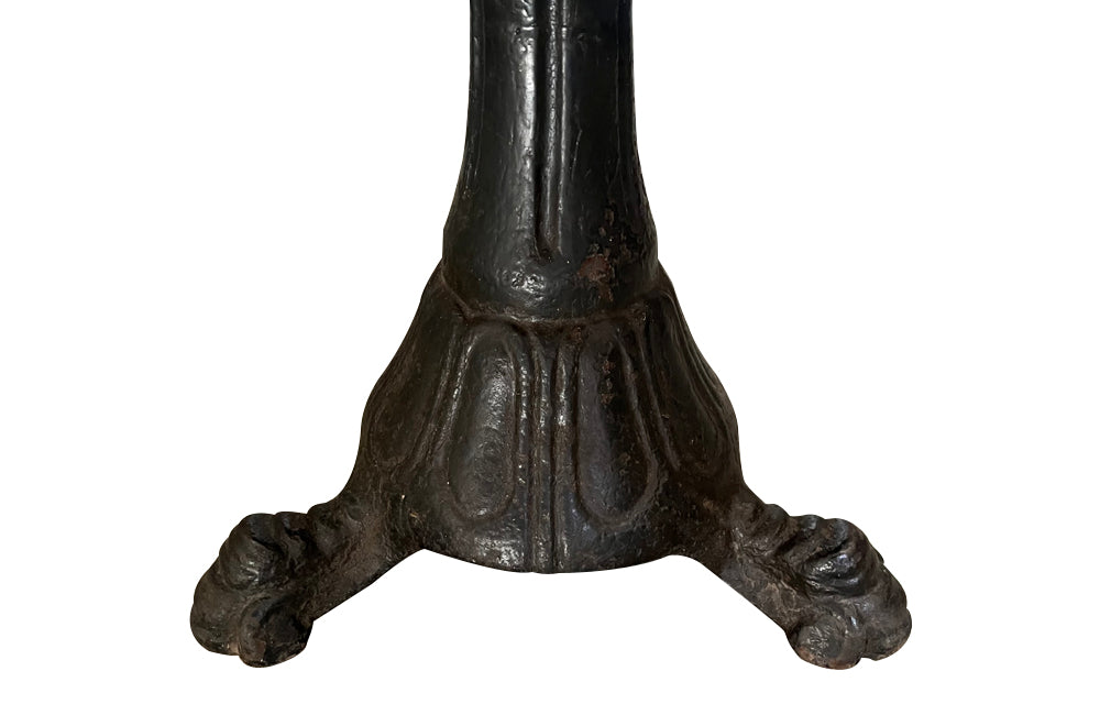 19th Century French carved wooden ships chair with leather seat and heavy cast iron base.