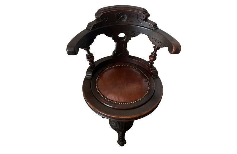 19th Century French carved wooden ships chair with leather seat and heavy cast iron base.