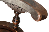 19th Century French carved wooden ships chair with leather seat and heavy cast iron base.