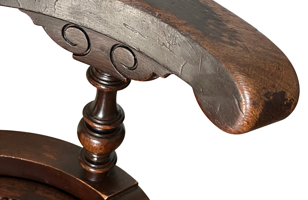 19th Century French carved wooden ships chair with leather seat and heavy cast iron base.