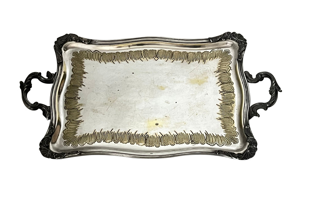 Decorative early 20th Century French Louis XV style worn silver plate on brass tray with ornate handles.