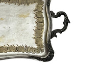 Decorative early 20th Century French Louis XV style worn silver plate on brass tray with ornate handles.