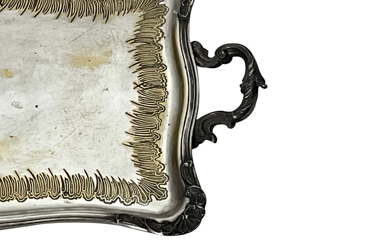 Decorative early 20th Century French Louis XV style worn silver plate on brass tray with ornate handles.