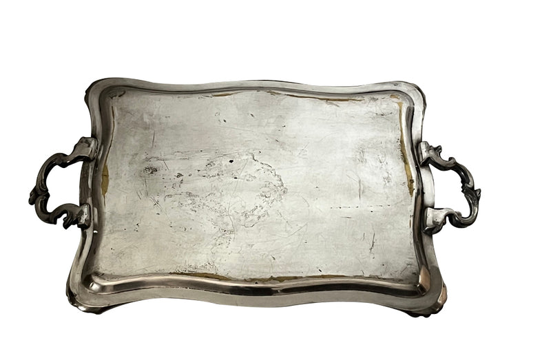 Decorative early 20th Century French Louis XV style worn silver plate on brass tray with ornate handles.