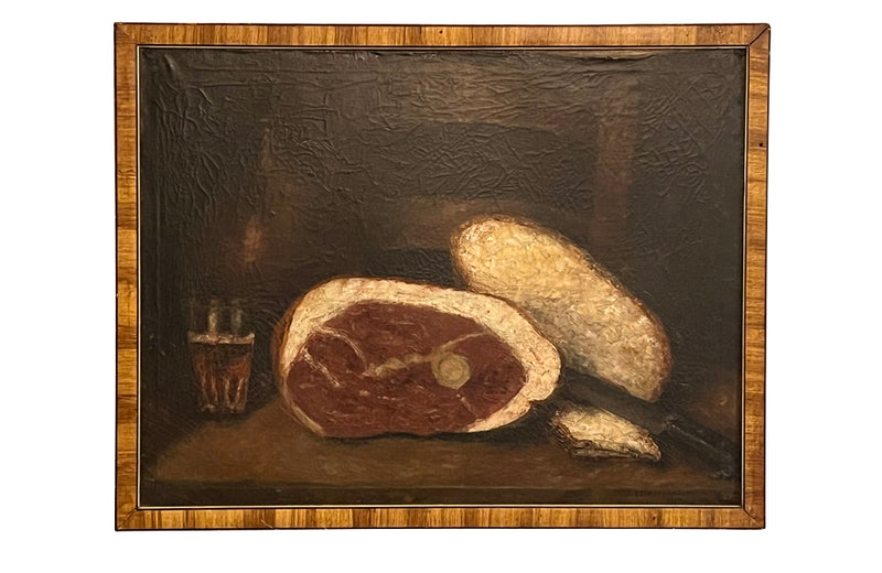 Signed still life painting depicting a glass of ale, cured meat, bread, knife and bottle on a table with chair