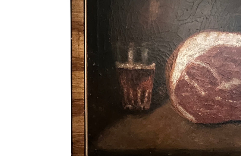 Signed still life painting depicting a glass of ale, cured meat, bread, knife and bottle on a table with chair