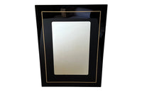 Stylish, black acrylic framed mirror with brass banding. Italy circa 1970