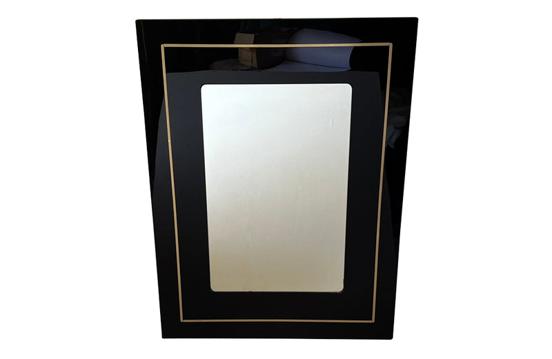 Stylish, black acrylic framed mirror with brass banding. Italy circa 1970