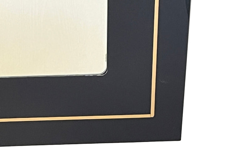 Stylish, black acrylic framed mirror with brass banding. Italy circa 1970