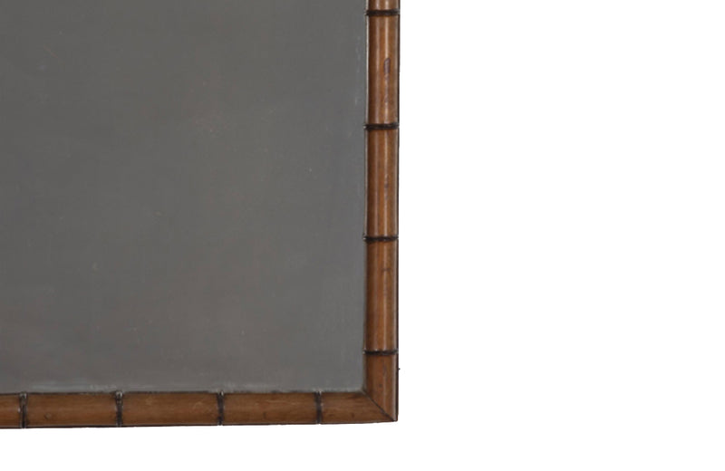 Early 20th century French faux bamboo framed mirror with triangular crossed arch top