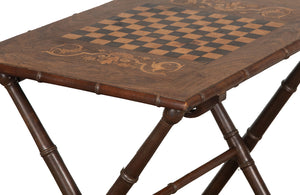 Early 20th century Faux Bamboo folding games table with inlaid checkerboard to centre and marquetry decoration.