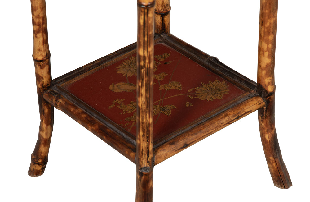 bamboo occasional table with its original red lacquer top and lower shelf, both beautifully decorated with chinoiserie gilt birds and flowers.