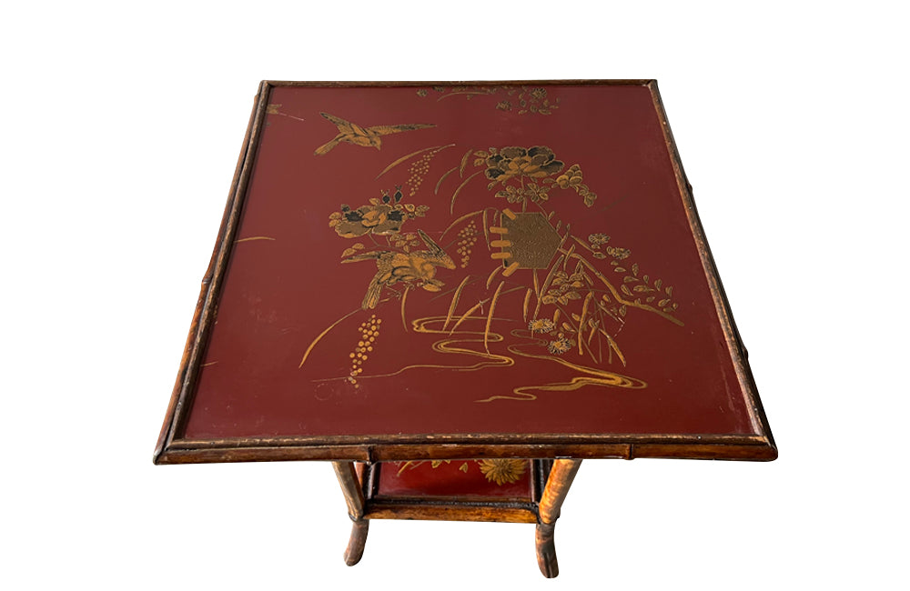 bamboo occasional table with its original red lacquer top and lower shelf, both beautifully decorated with chinoiserie gilt birds and flowers.