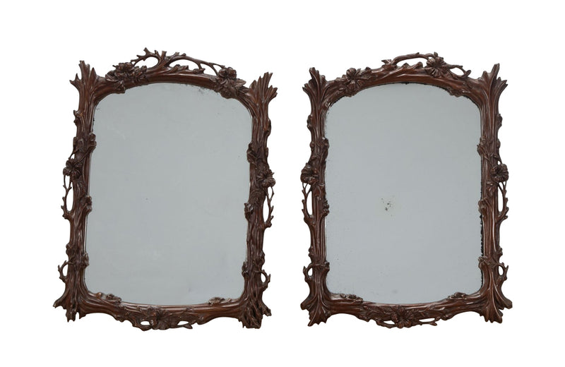 Pair of 20th Century decorative mirrors carved with climbing branches and flowers.&nbsp;