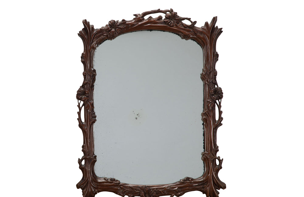 Pair of 20th Century decorative mirrors carved with climbing branches and flowers.&nbsp;