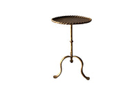 Chic, Spanish, gilt iron cocktail table with hammered and rope rim top on hammered ringed stem and decoratively shaped tripod base.