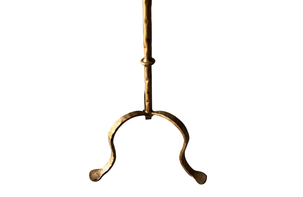 Chic, Spanish, gilt iron cocktail table with hammered and rope rim top on hammered ringed stem and decoratively shaped tripod base.