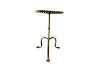 Chic, Spanish, gilt iron cocktail table with hammered and rope rim top on hammered ringed stem and decoratively shaped tripod base.