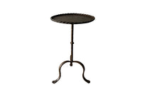 Spanish, gilt iron cocktail table with hammered and rope rim top on hammered ringed stem and decoratively shaped tripod base.