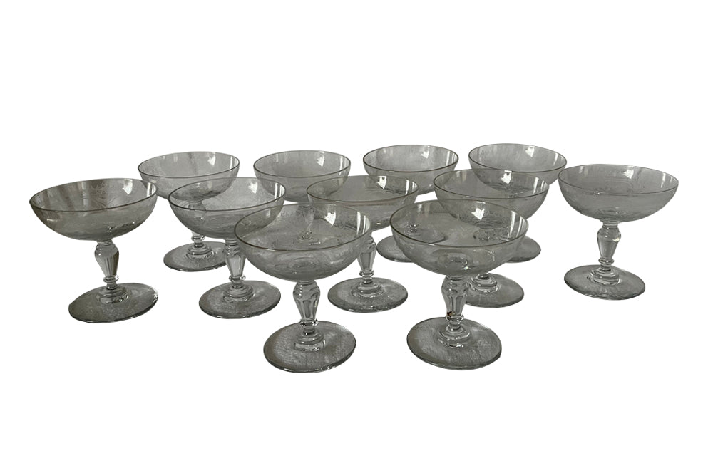 Beautiful set of 11 French champagne coupes decorated with a neo-classical etched design featuring galands of flowers.  c.1900