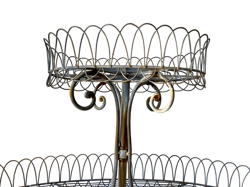 Antique metal plant stand made of iron work with three tiers