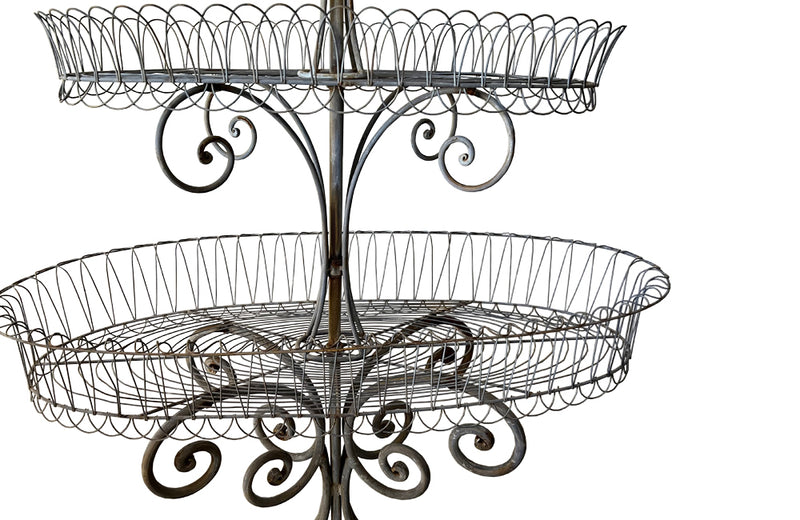 Antique metal plant stand made of iron work with three tiers