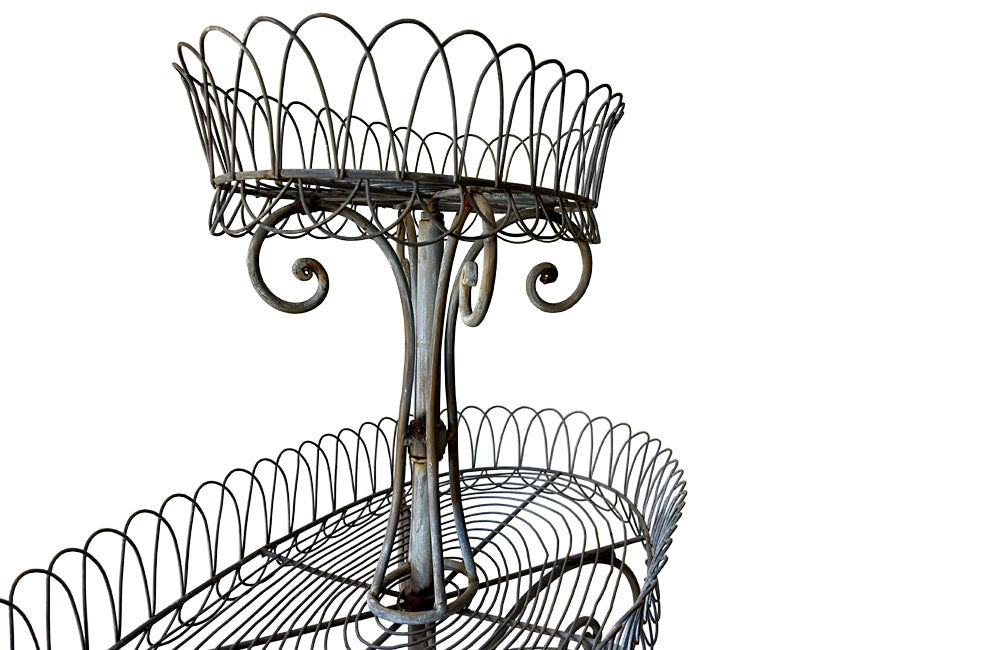 Antique metal plant stand made of iron work with three tiers