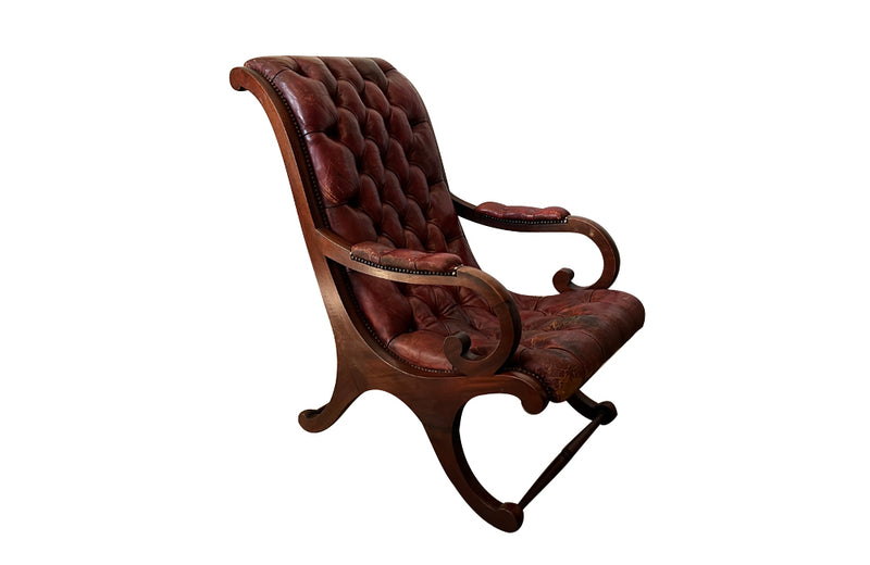 20th Century mahogany Regency Revival armchair with worn red buttoned leather.