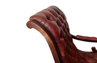 20th Century mahogany Regency Revival armchair with worn red buttoned leather.